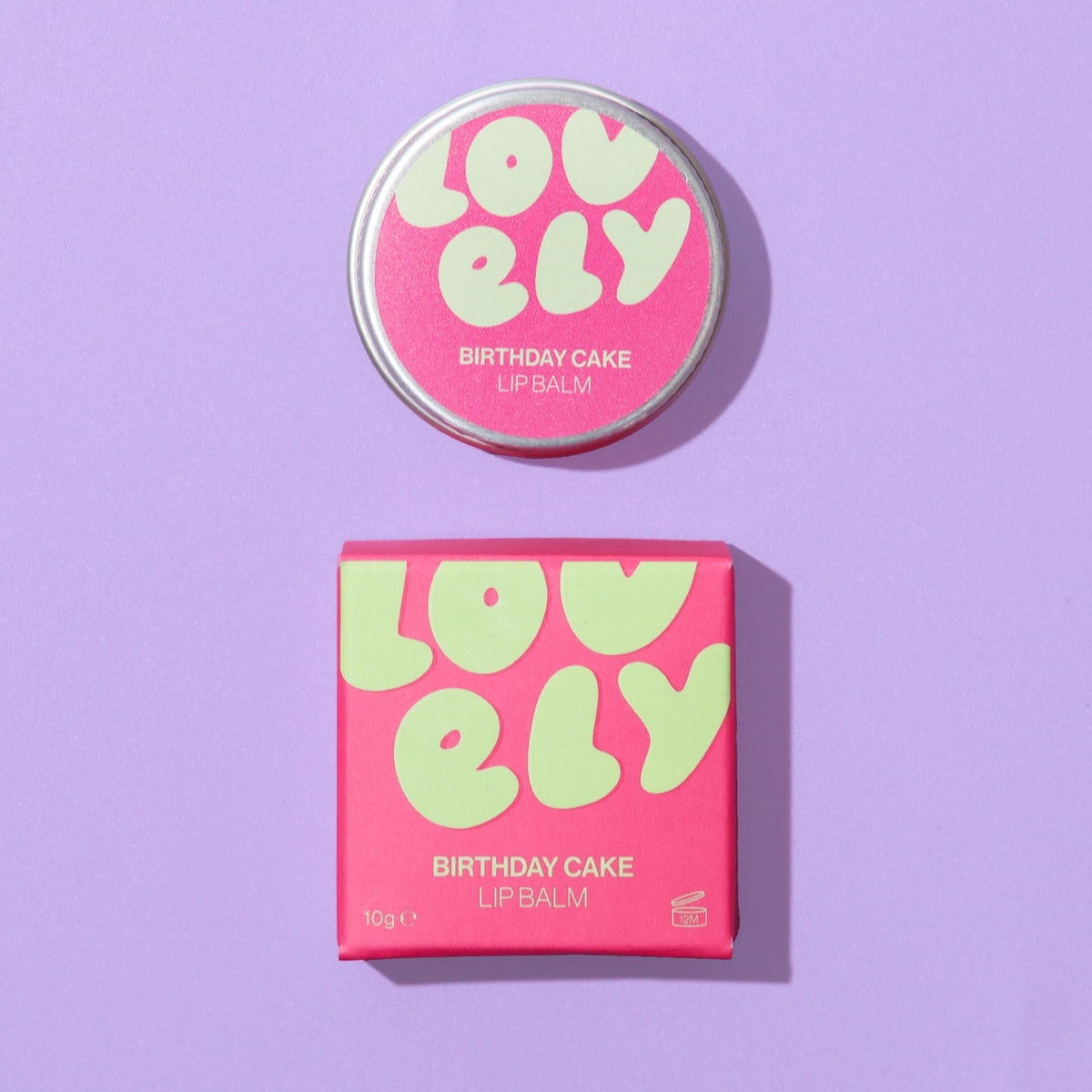 Lovely Skincare Birthday Cake lip balm with packaging on a purple background background.
