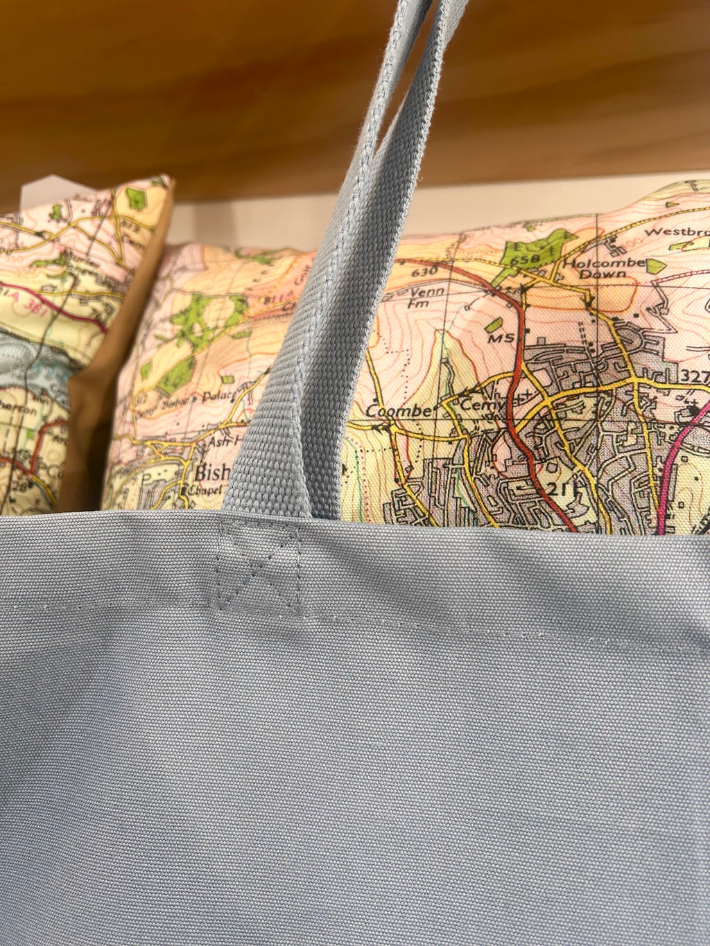Blue tote bag with a map in the background