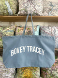 Blue tote bag with 'BOVEY TRACEY' text on a background of vintage maps