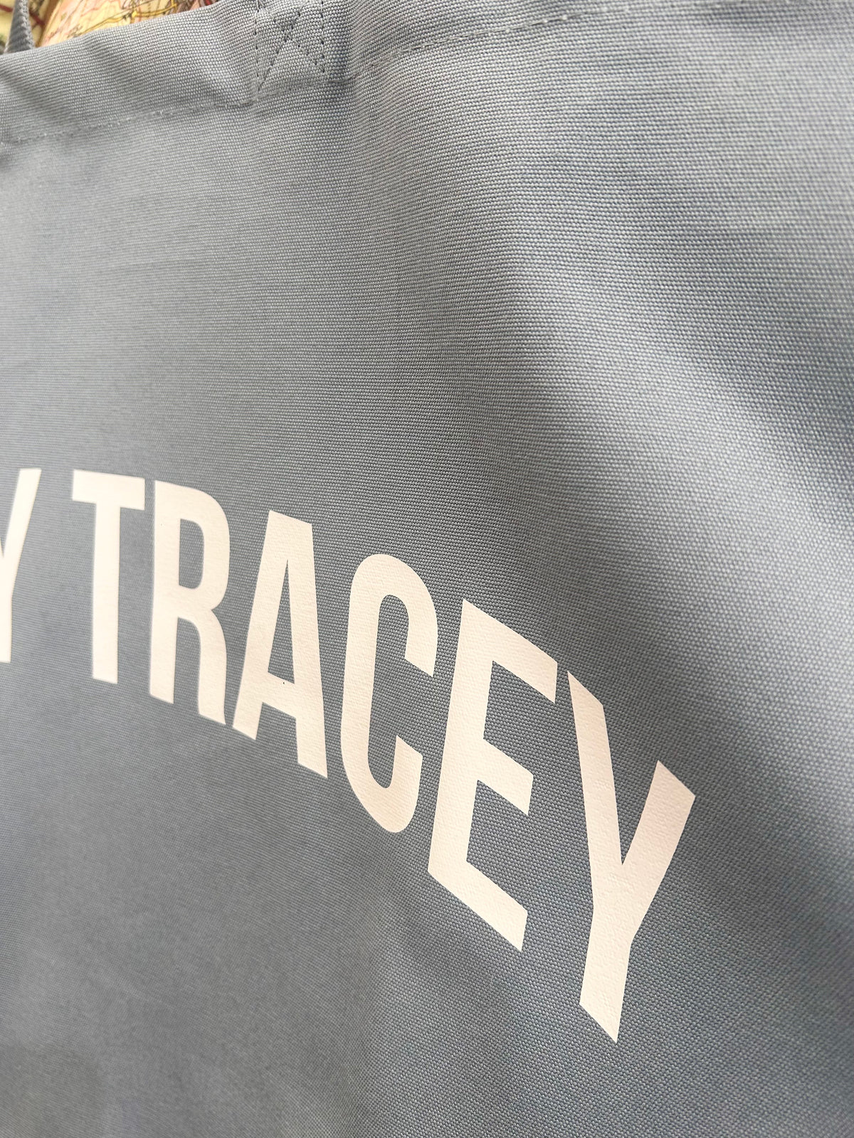 Blue tote bag with 'BOVEY TRACEY' printed in white letters.