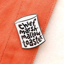 Pin with 'Chief Marshmallow Toaster' text on a textured surface