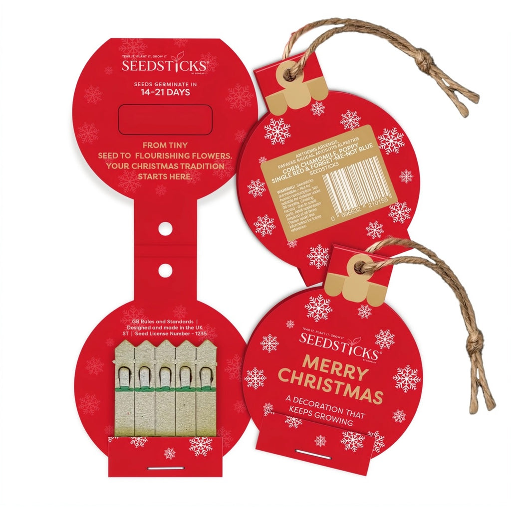 Seedsticks Christmas bauble shaped seed packets with white snowflakes, gold ribbon, and twine loops, shown on a plain white background. The packagng is open to show the actual seedsticks.