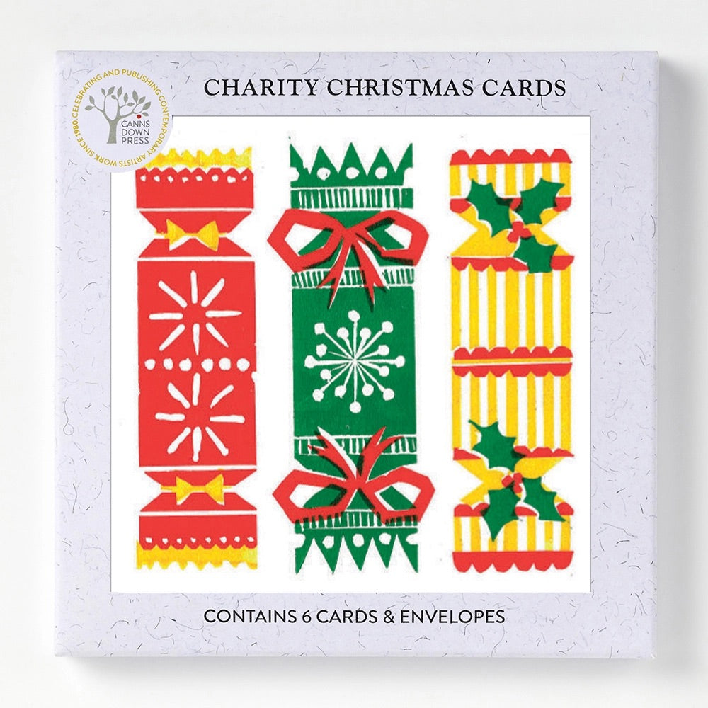 Three colourful and patterned Christmas crackers feature on a joyful Christmas card, n a boed pack of 6