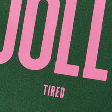 Close up of Jolly Tired text in pink on green tote bag by Alphabet Bags