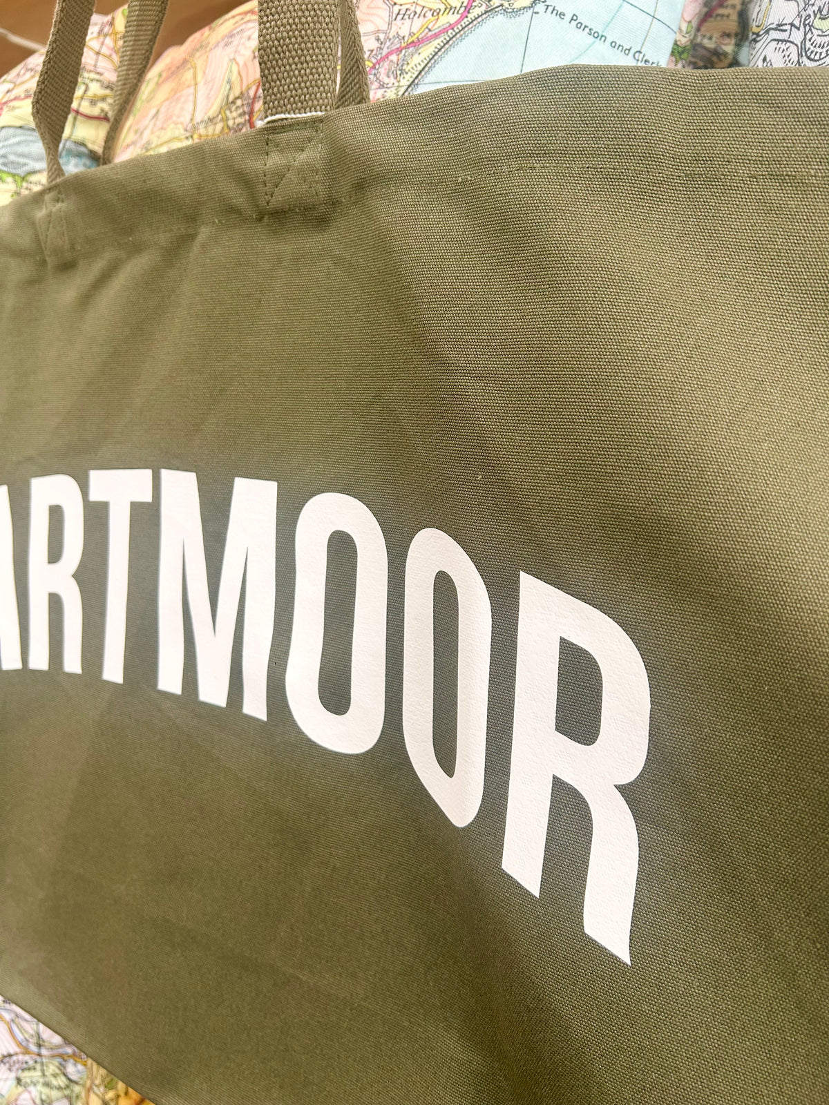 Green bag with 'DARTMOOR' printed on it, close-up view.