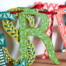 Close up of letters in Merry Christmas Banner by Cambridge Imprint in red and green