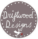 Driftwood Designs logo with a dove and heart on a grey background.