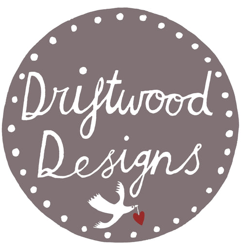 Driftwood Designs logo with a dove and heart on a grey background.