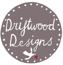 Driftwood Designs logo with a dove and heart on a gray background