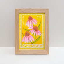 Framed risograph print of echinacea flowers in shades of pink with green stems against yellow background in style of vintage postage stamp. 