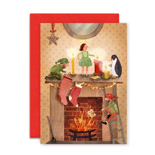 Christmas card with illustrations of elves and a penguin by a fireplace.