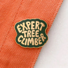 Pin with 'Expert Tree Climber' text in gold with a green background. 
