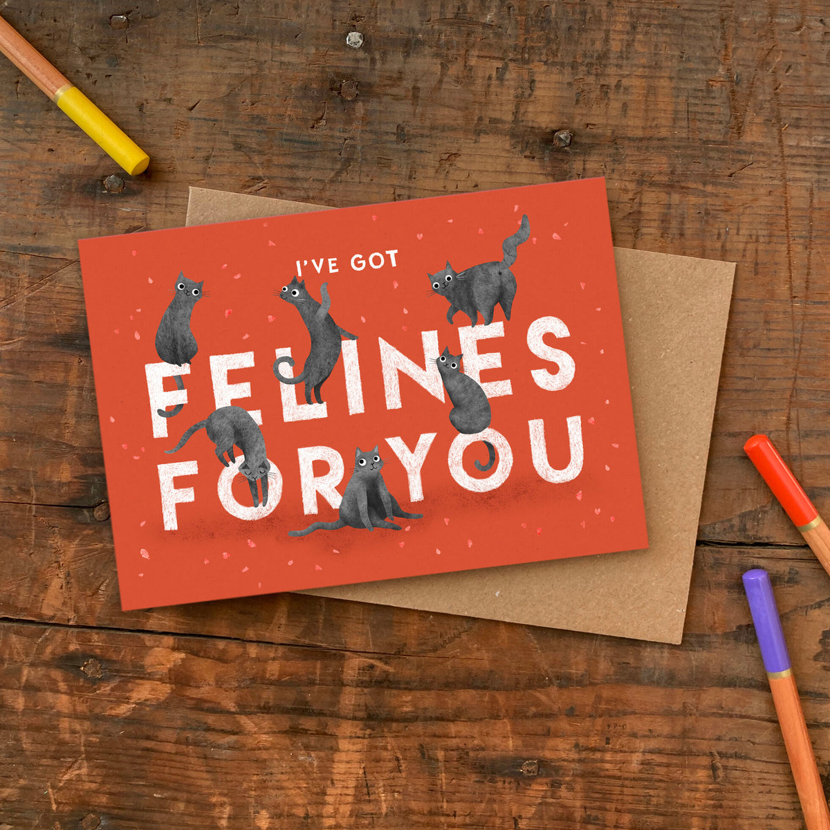 Greeting card with illustrated playful cats and the text 'I've got felines for you' on a red background.