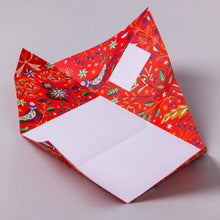 Festive Pigeon letter being folded in an example of how they work.