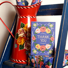 Decorative Floral Card with blue background and text reading 'Thank You', set against a floral painted red jug.