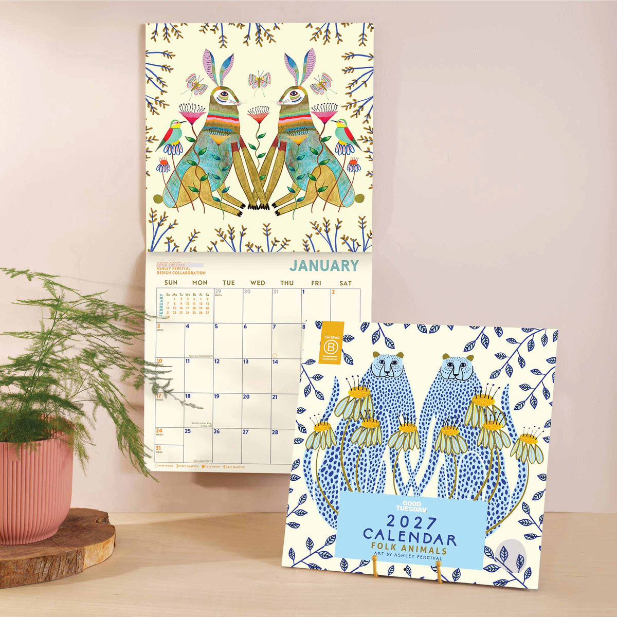 2027 calendar with colorful folk animal design on a light surface with a plant in the background