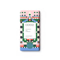 A single rectangular chocolate bar wrapped in a colorful geometric paper sleeve, centered on a plain white background. The wrapper features a pink top section, a blue bottom section, and a central white panel with black text reading 'COCO GINGERBREAD MILK CHOCOLATE'.