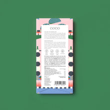 The back of a chocolate bar package by Coco, featuring a pastel pink and blue geometric pattern with a white label, centred on a solid green background.