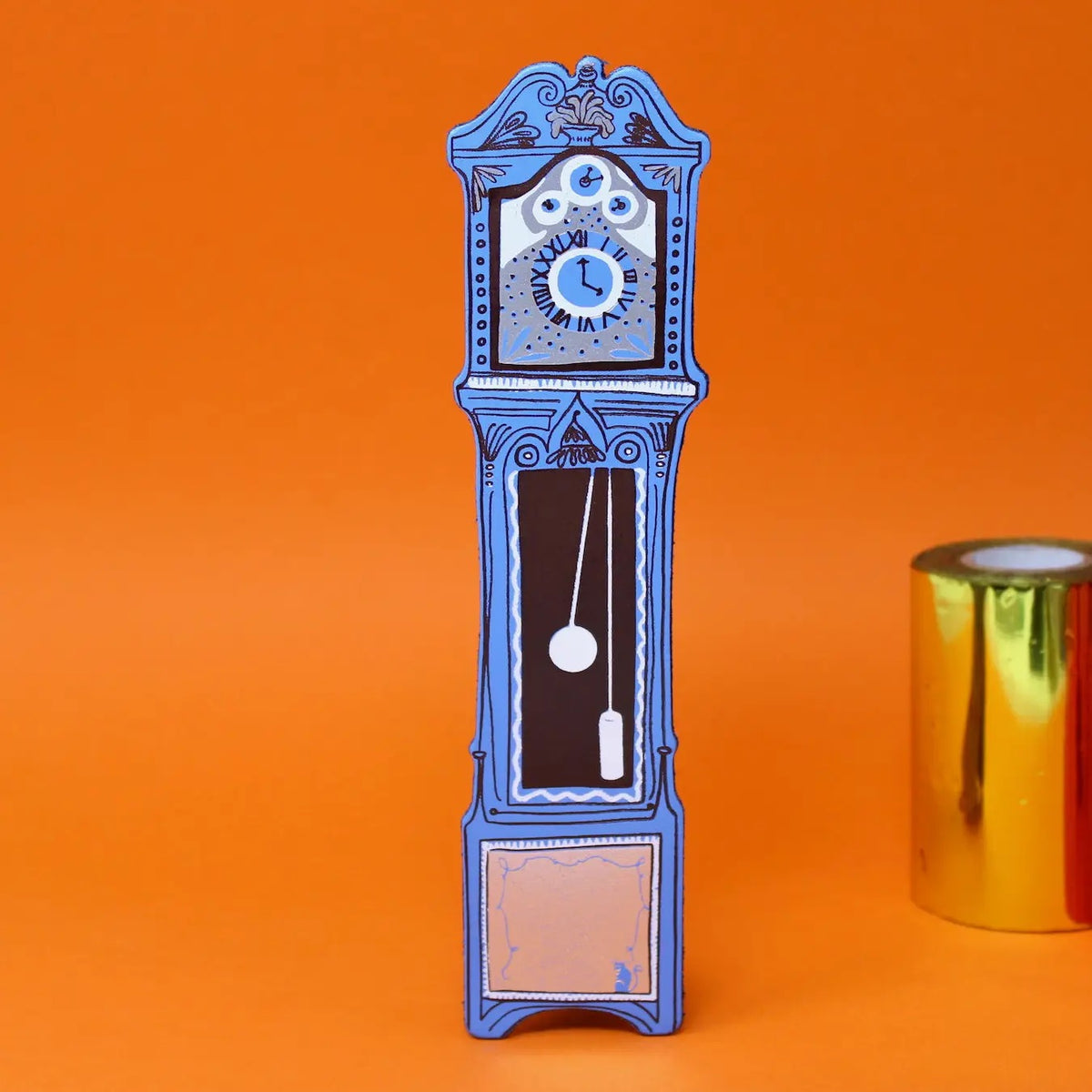 Blue leather grandfather clock bookmark on an orange background 