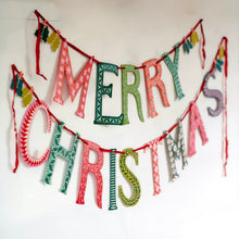 Decorative 'Merry Christmas' banner with colorful letters on a white background