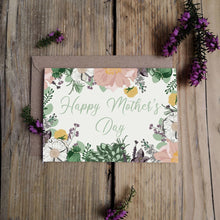 Floral Mother's Day card with envelope on a wooden surface