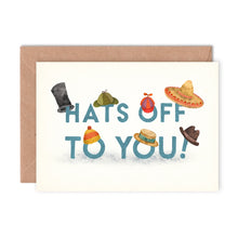 Greeting card with various hats and 'Hats Off To You!' text on a white background with kraft envelope