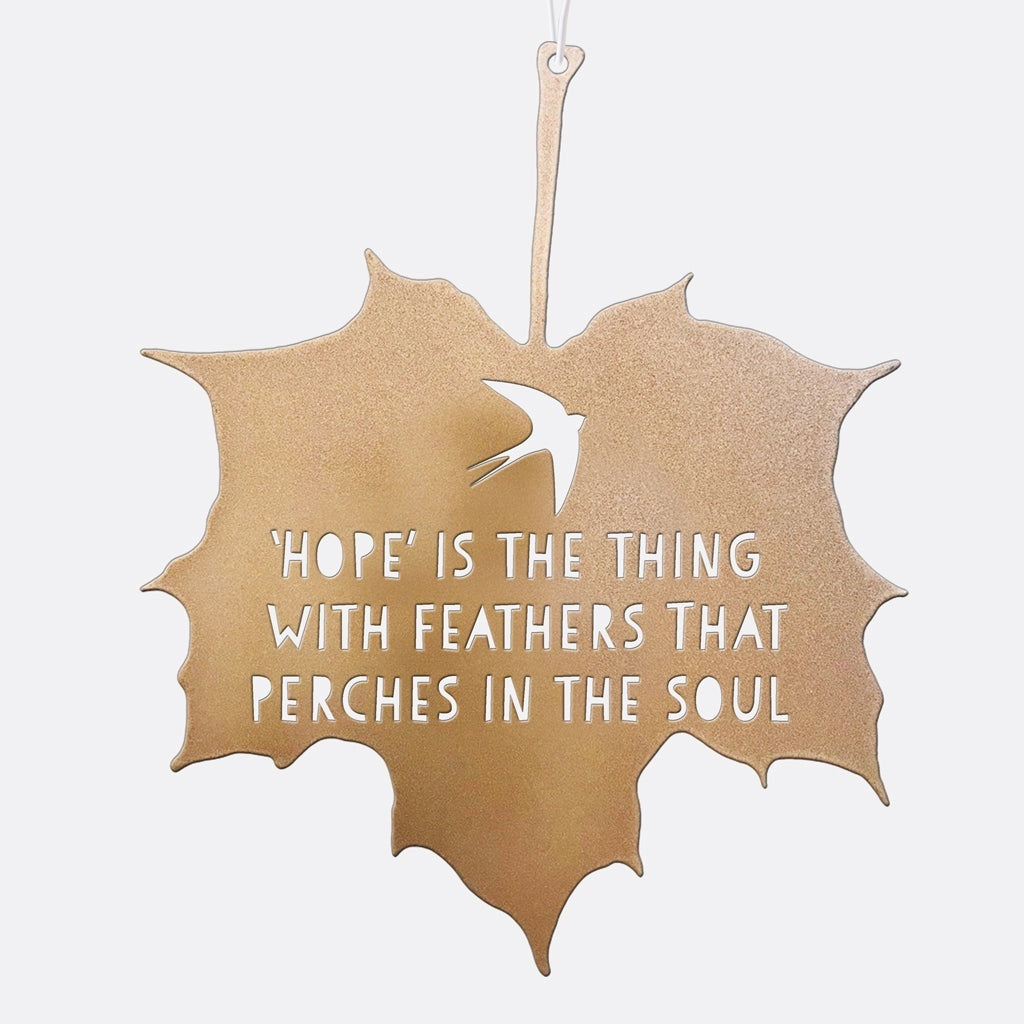 Decorative leaf-shaped sign with a quote on a white background