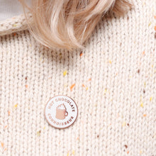 Enamel pin with 'Hot Chocolate Connoisseur' text and hot chocolate illustratin in centre 