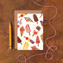 Greeting card with ice cream illustrations on a wooden surface with a pen and string.