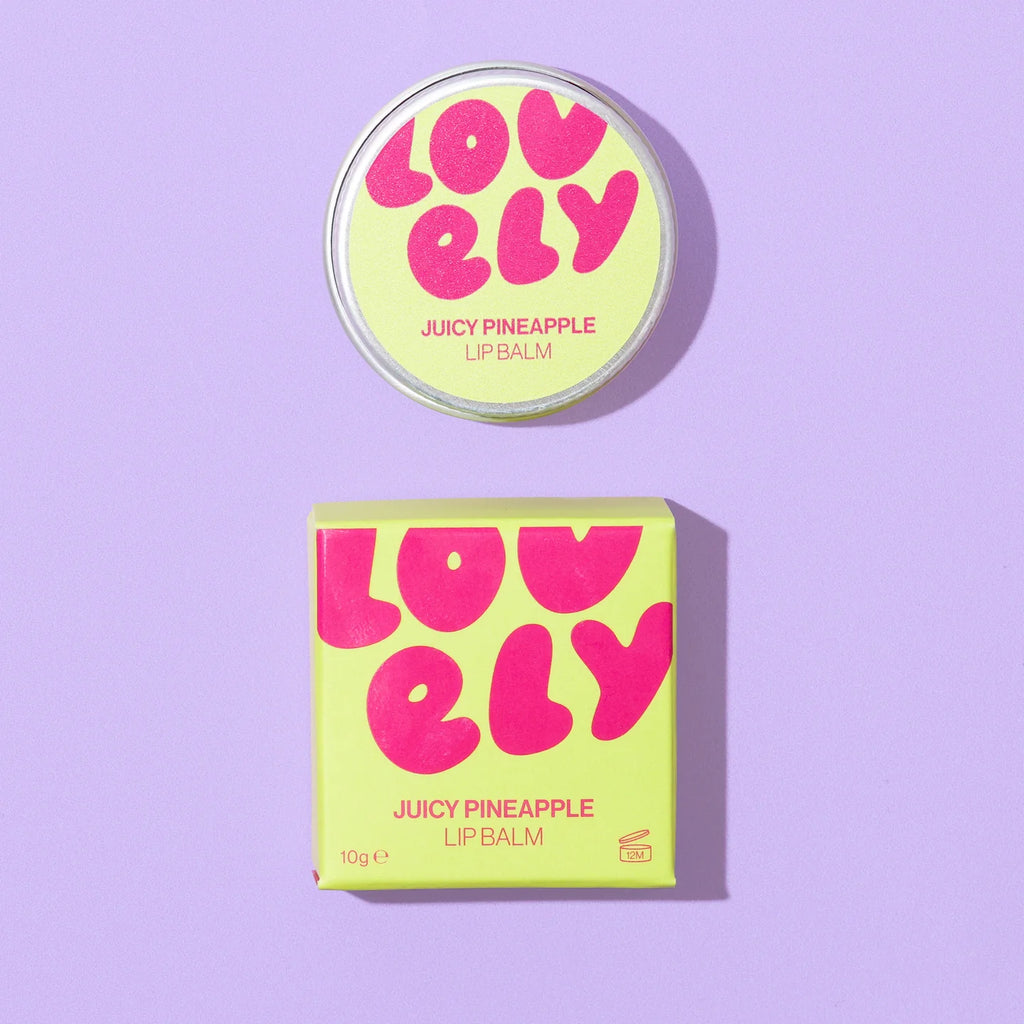 Lovely Skincare's Juicy Pineapple Lip Balm  round tin and its matching square box on a light purple background. 
