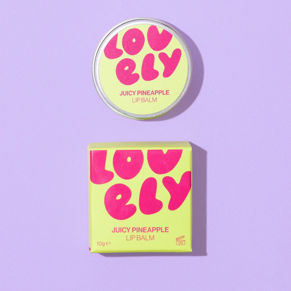 Lovely Skincare's Juicy Pineapple Lip Balm  round tin and its matching square box on a light purple background. 