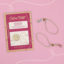 Cotton Twist friendship bracelet kit with a completed bracelet on a pink background