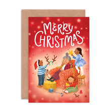 Christmas card with illustrations of children decorating a Grandma, sat in a chair, with 'Merry Christmas' text.