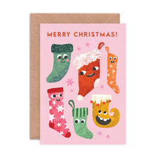 Christmas card with colourful smiley stockings on a pink background