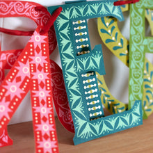 Close up of letters from Merry Christmas Banner by Cambridge Imprint
