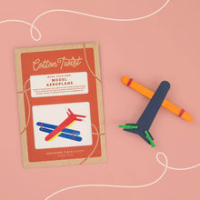 Cotton Twist model aeroplane kit with cardboard packaging on a pink background