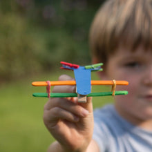 Child playing with colourful aeroplane toy made from Cotton Twist kit