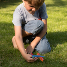 Child playing with colorful aeroplane toy made from Cotton Twist kit