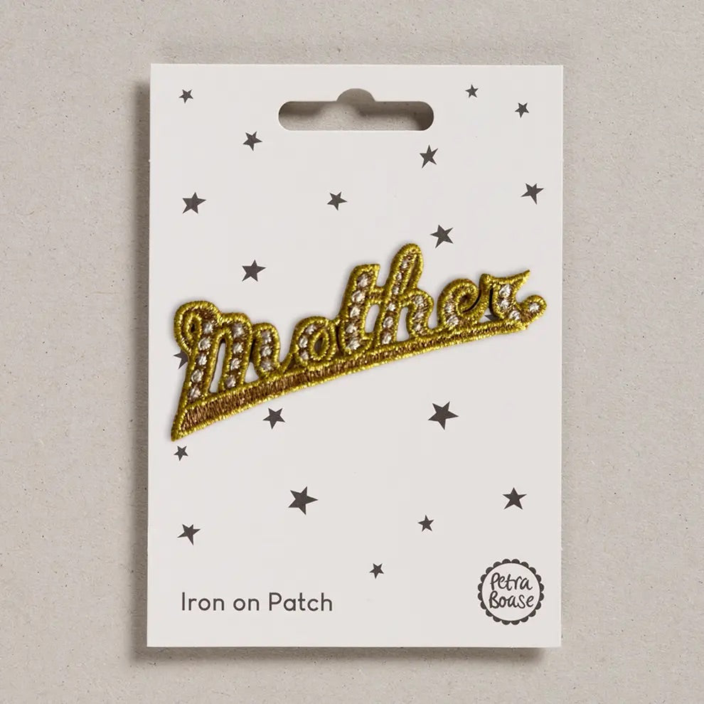 Gold 'Mother' iron on patch on a white card with star patterns, brand 'Petra Boase' visible.