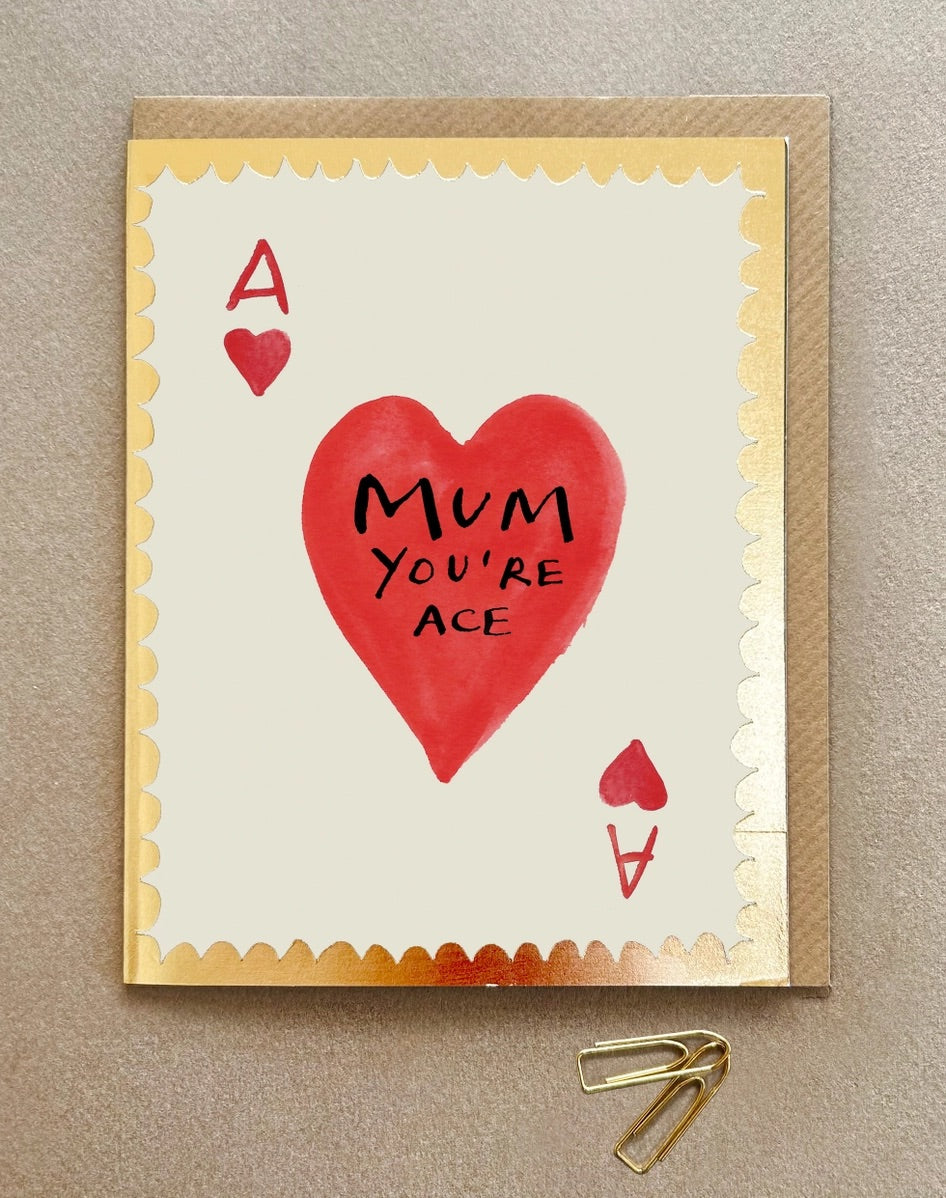 Card with red heart and 'Mum you're ace' text and gold foil border on a beige background
