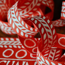 Close up of paper chains in red and white printed leaf design by Cambridge Imprint