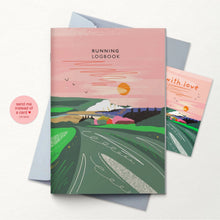 A running logbook with a pink and green illustrated cover showing a landscape and the title 'RUNNING LOGBOOK,' displayed with grey envelope on a white background. 