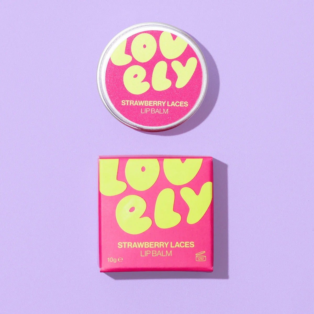 Lovely Skincare's strawberry laces lip balm tin and boxed packaging on a purple background