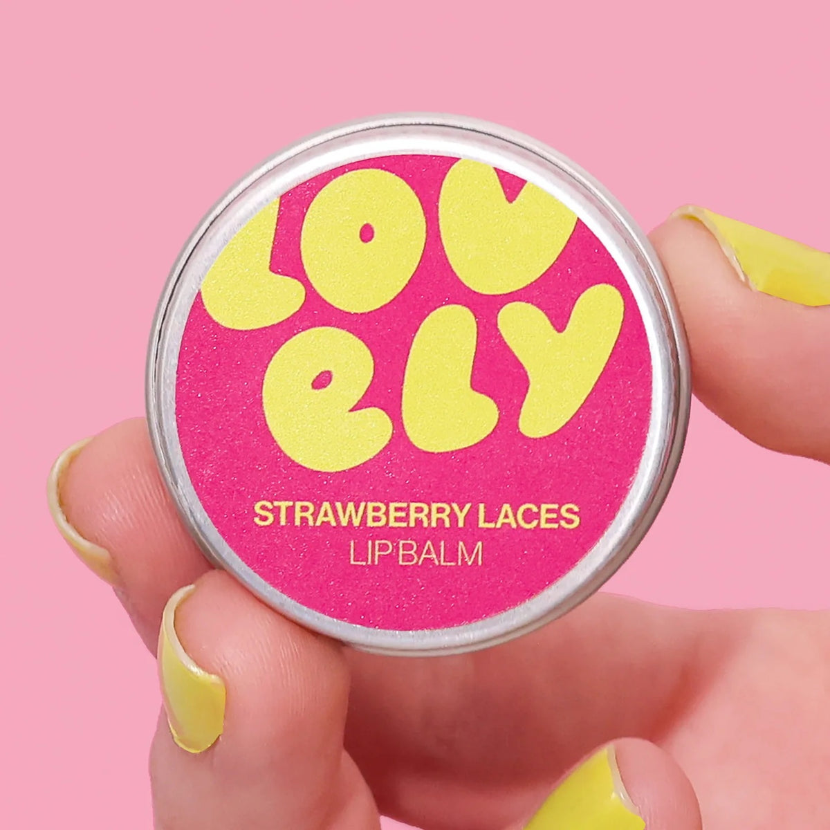Lip balm container with 'Lovely Strawberry Laces' text on a pink background