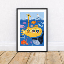 Framed children's illustration of a yellow submarine with sea creatures on a white wall.