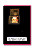A fun Christmas card or featuring a vintage Santa Claus figure decoration glowing in a window, surrounded by darkness. A white speech bubble at the bottom reads, 'YOU BETTER WATCH OUT. YOU BETTER NOT CRY.'